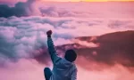 Man triumphant on mountain at sunrise Man triumphant on mountain at sunrise